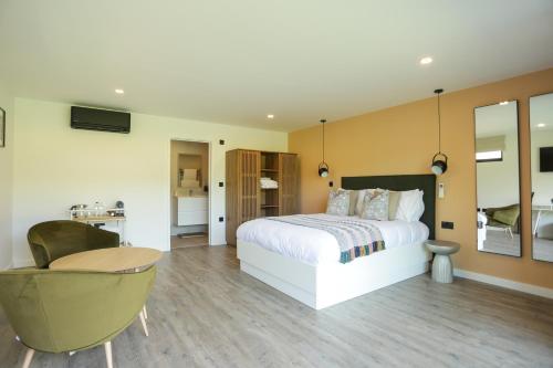 a bedroom with a bed and a desk and a chair at Chapel House Estate in Kent