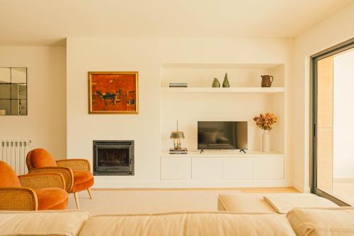 a living room with a couch and a tv at Casa Cascais Riviera - Deluxe 3 Bedroom Apartment in Cascais