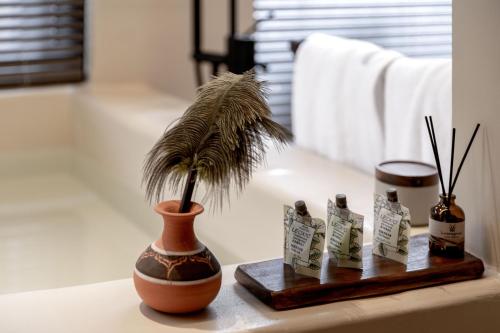 a plant in a vase sitting on a table at M ORIGINAL VILLA in Jinghong