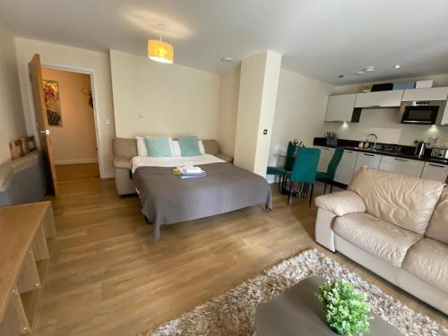 a living room with a bed and a couch at Canada Water 2Bedroom Apartment in London