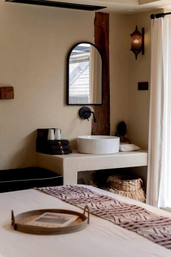 a bathroom with a sink and a mirror at M ORIGINAL VILLA in Jinghong