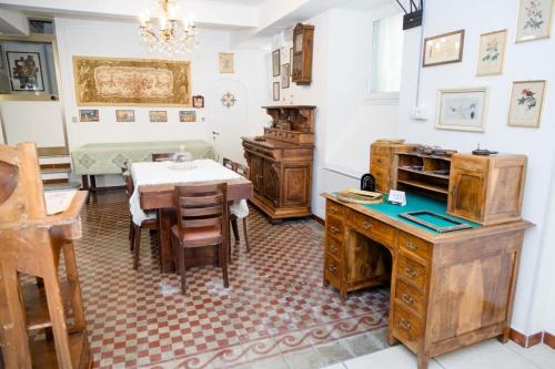 a dining room with a table and wooden furniture at B&B Casa Rosso - Le Cantine in Cisano sul Neva