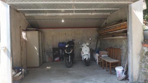 a garage with a motorcycle parked in it at A 2 Colli dal Mare in Varazze