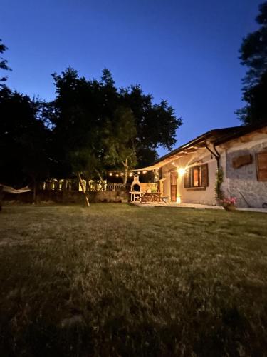 a house lit up at night with a yard at Dimore Di Charme Lago Matese in San Gregorio