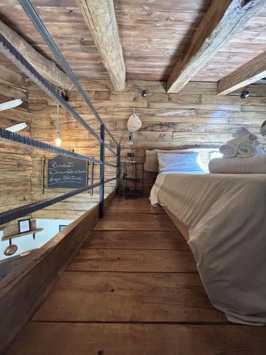 a bedroom with wooden walls and a bed in a room at Dimore Di Charme Lago Matese in San Gregorio
