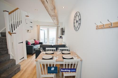 a dining room and living room with a table and chairs at 2 Bed House By Southern Stays Short Lets & Serviced Accommodation Bournemouth With Parking - Relocation & Family, 1km From The Beach in Bournemouth