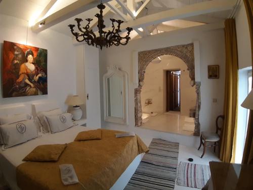 a bedroom with a large bed and a mirror at Alex's Guesthouse with a pool in Dhomátia
