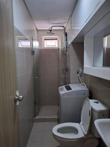 a small bathroom with a toilet and a shower at SMDC Good Stays - Shore Residences 2 Bedroom in Manila