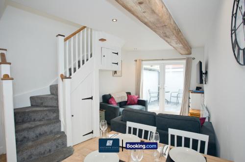a living room with a couch and a table at 2 Bed House By Southern Stays Short Lets & Serviced Accommodation Bournemouth With Parking - Relocation & Family, 1km From The Beach in Bournemouth
