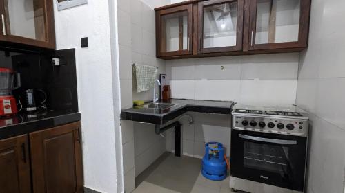 a small kitchen with a sink and a stove at Mayon Beach villa in Tangalle