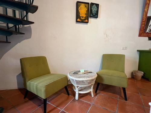 two chairs and a table in a room at East Indies Mansion in George Town