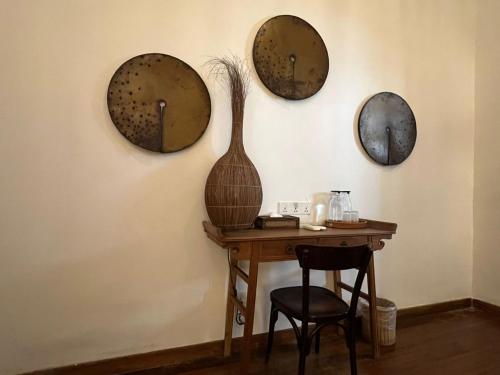 a room with a table and four mirrors on the wall at East Indies Mansion in George Town