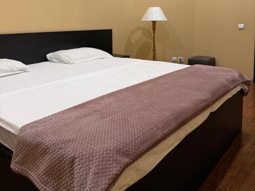 a large bed with a blanket on top of it at Kalachi guest house Armenia in Yerevan