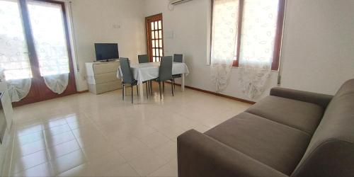 a living room with a table and a couch at Sole e Luna in San Vito