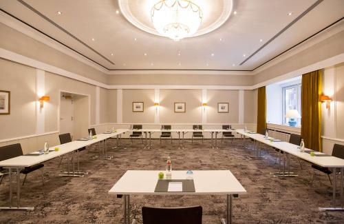 a large room with tables and chairs and a chandelier at Hotel Essener Hof; Sure Hotel Collection by Best Western in Essen