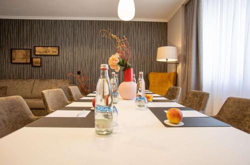 a long table with bottles on top of it at Hotel Essener Hof; Sure Hotel Collection by Best Western in Essen