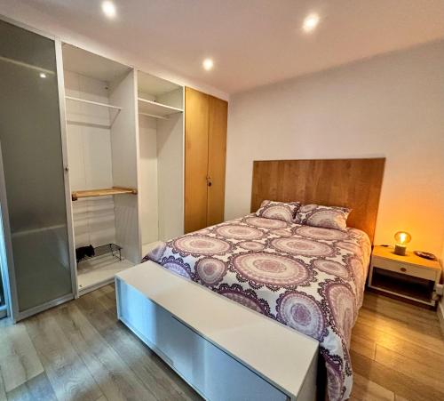 a bedroom with a large bed with a wooden headboard at Casa Miká in Parede