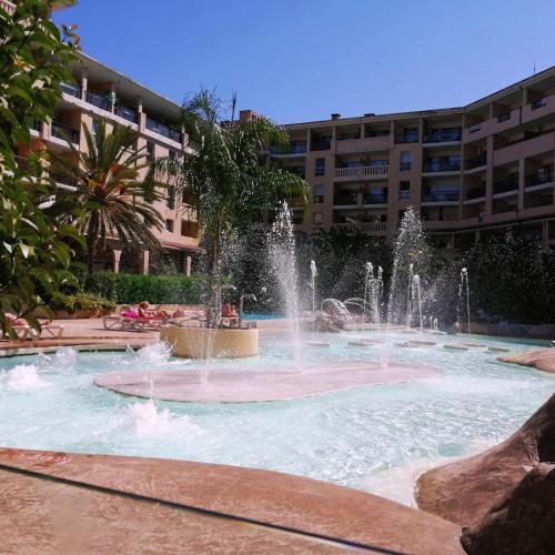 a fountain in a pool in front of a building at ON VACAY - Votre havre de paix à 100 m des plages in Cannes