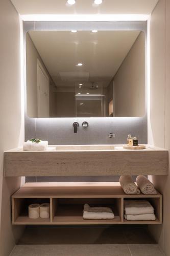 a bathroom with a sink and a large mirror at Alma Eilat Garden Apartment with Private Pool in Eilat