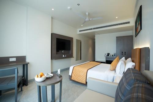 a hotel room with a bed and a couch at ZiP By Spree Hotels Pandharpur in Pandharpur