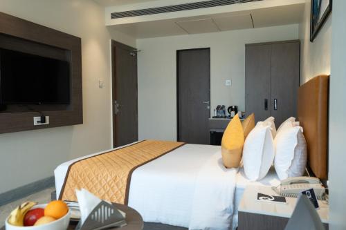a hotel room with a bed and a television at ZiP By Spree Hotels Pandharpur in Pandharpur