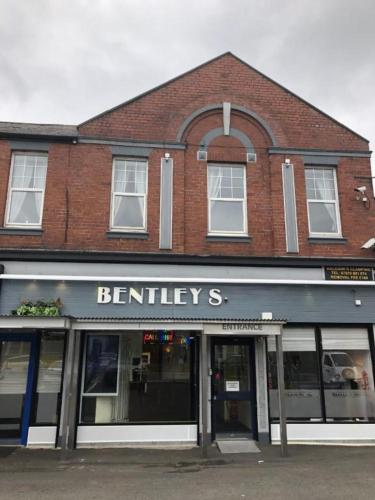 a brick building with a sign on the front of it at OYO The Bentleys Hotel in Newcastle upon Tyne
