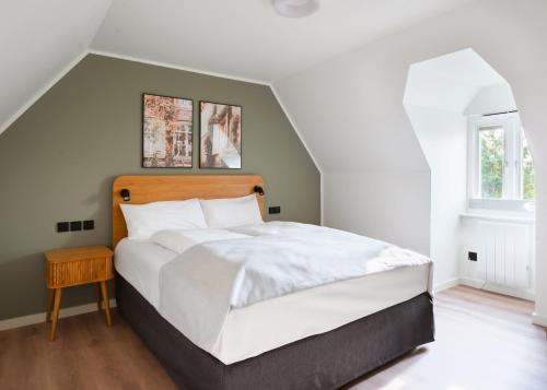 a bedroom with a large white bed and a window at Limehome London Streatham High Rd in London