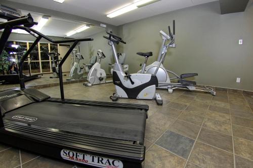 a gym with several exercise bikes and a treadmill at Victoria Inn Hotel & Convention Centre Brandon in Brandon