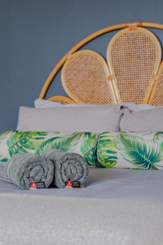 a pair of towels sitting on top of a bed at Hermanus Waterfront Boho Studio Apartment, Whale Coast Hideaway in Hermanus