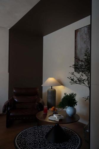 a living room with a couch and a table at Shuxia · Summer Lijiang Baisha Snow Mountain Scenic Hotel in Baisha