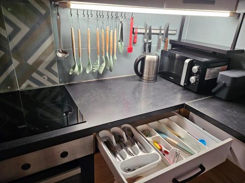 a kitchen with a drawer filled with utensils at Radoslove Apt in Radovljica