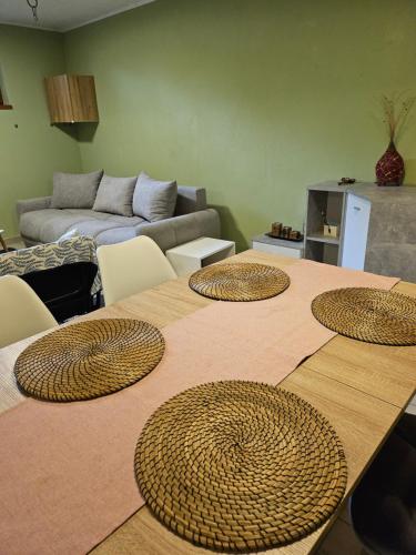 a room with a table with five brown rattan plates on it at Radoslove Apt in Radovljica