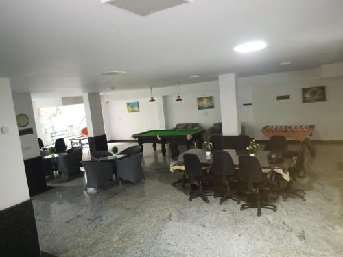 a living room with a pool table and chairs at Anant in Jāmb