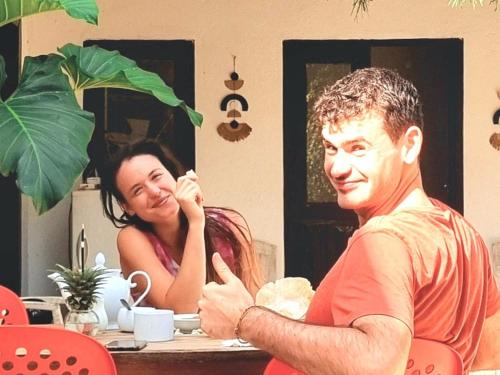 a man and a woman sitting at a table at Ocean Beach House in Matara