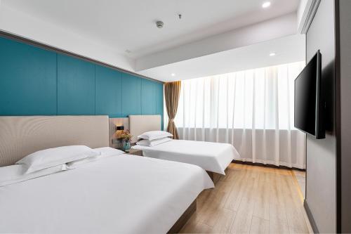 Cama o camas de una habitación en Xiangshang Hotel&Canton Fair Shuttle Bus
