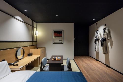 a hotel room with a bed and a desk and a mirror at Mitasuya Ryokan Hotel by Aank Cheonan in Cheonan