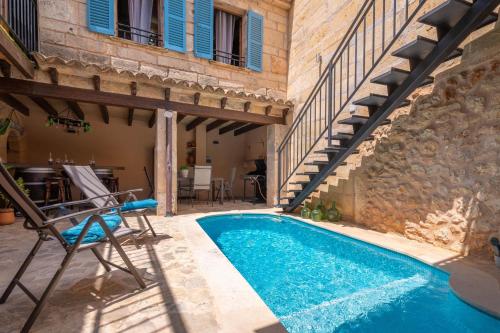 a pool in a house with a patio and stairs at Ca's Mercader -Algaida- in Algaida