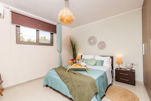 a bedroom with a bed with a tray on it at Villa Eleanna Pastras Residence in Vanáton