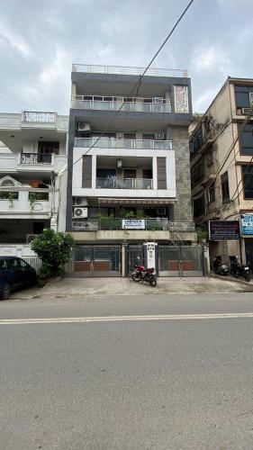 a tall building with a motorcycle parked in front of it at Cassava Stay in New Delhi