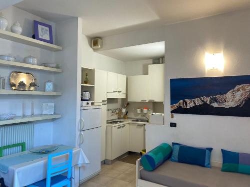 a kitchen with a couch and a table in a room at Bilocale atelier in centro storico in Parma