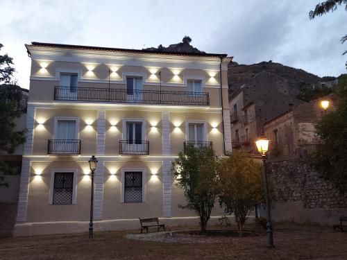a white building with lights on the side of it at Al Monumento bed & breakfast in Amantea