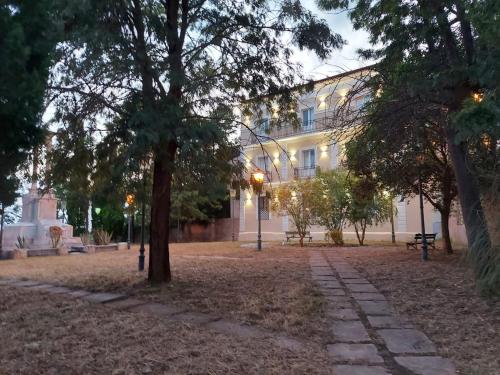 a building with a tree in the middle of a park at Al Monumento bed & breakfast in Amantea