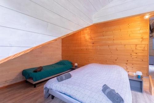 a bedroom with a bed in a wooden wall at Villa À Isturits Avec Piscine in Isturits