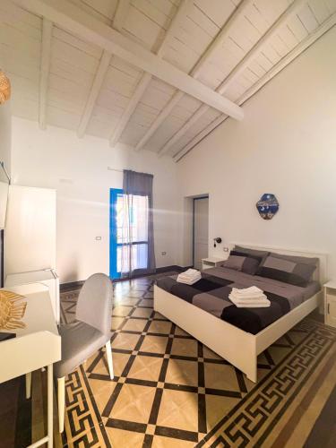 a large bedroom with a large bed and a chair at Cala Batteria - Camping & Village in Bisceglie