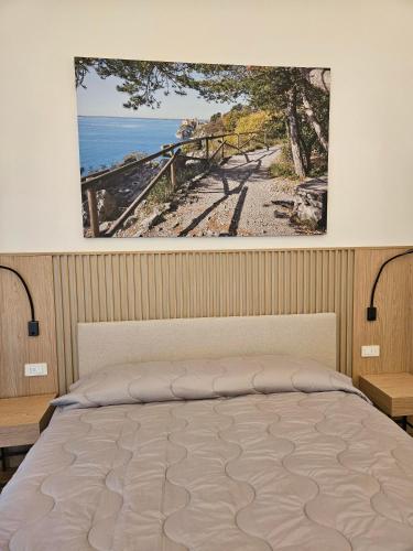 a bedroom with a bed with a picture on the wall at Camping Village Mare Pineta in Sistiana