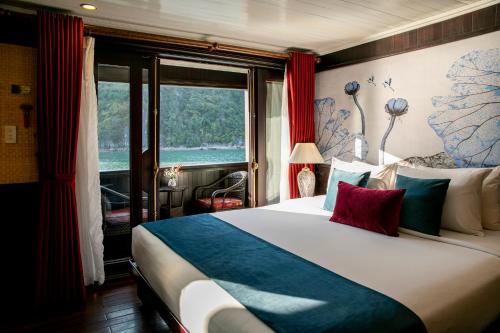 a bedroom with a large bed and a window at Bhaya Halong Cruises in Ha Long
