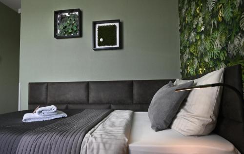 a bedroom with a bed with a couch in it at Hotel Bürgerhof in Cologne