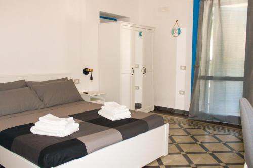 a bedroom with a bed with towels on it at Cala Batteria - Camping & Village in Bisceglie