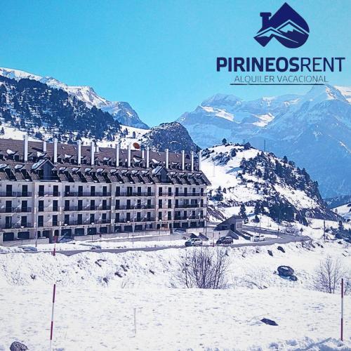 a hotel on top of a snow covered mountain at Apartamentos Pirineos Rent in Candanchú