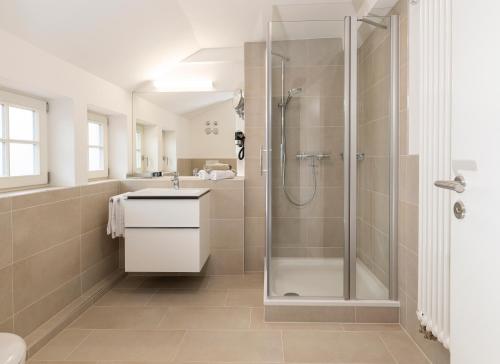 a bathroom with a shower and a sink at Wohnpark Hotel Heppenheim in Heppenheim an der Bergstrasse